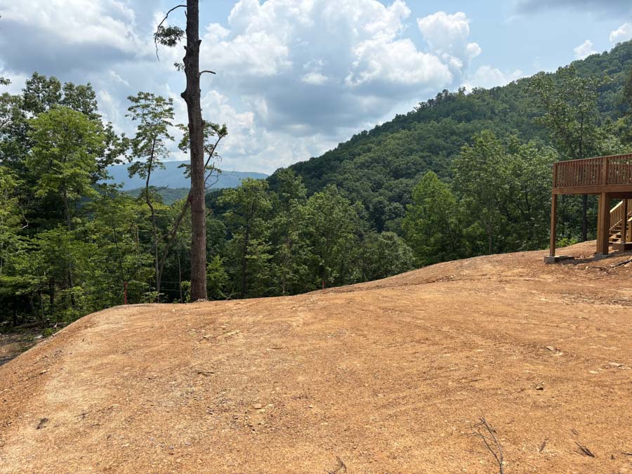 Cleared and graded hilltop home site with mountain views beside an existing deck: residential excavation by Rooney Excavating of Seymour, TN