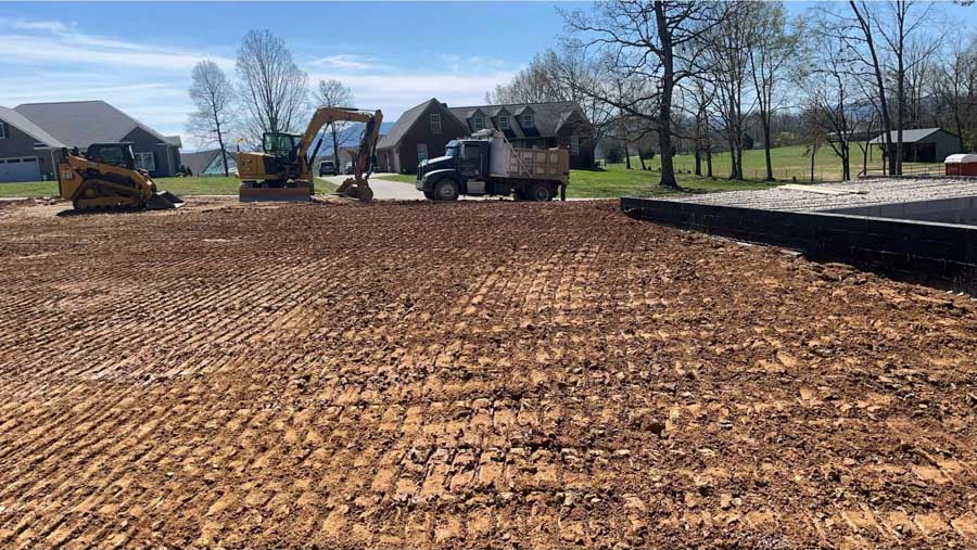 Skid steer, excavator and dump truck on a freshly graded lot in a residential subdivision: residential excavation by Rooney Excavating of Seymour, TN