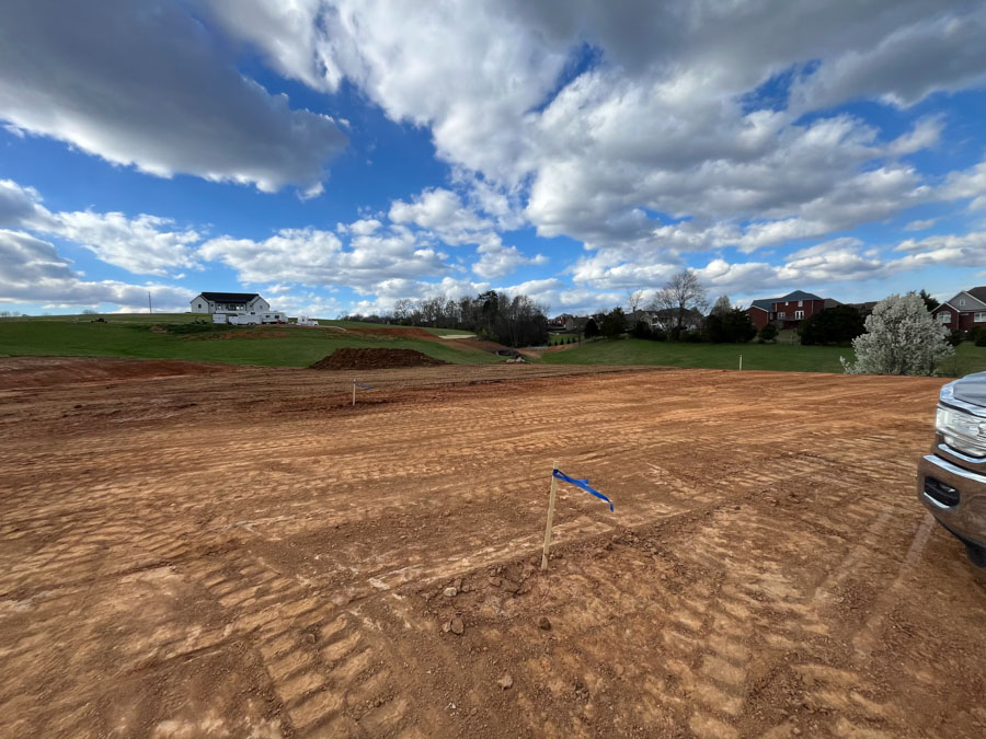 Cleared and graded subdivision lot marked with a survey flag, ready for construction: residential excavation by Rooney Excavating of Seymour, TN